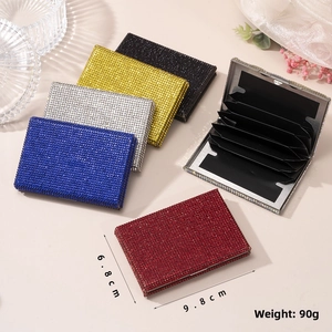 Macro detail of luxury rhinestone card holder showing accordion card slots and dimensions