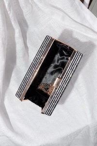 Detail of vintage cassette clutch with black and white rhinestones and rose gold frame