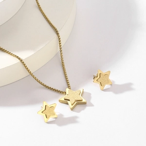 Detailed view of gold double-layer star necklace and matching stud earrings set