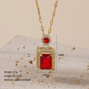 Detail view of gold necklace with red square pendant showing 40+5cm length and 3.7g weight