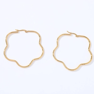 Close-up of gold stainless steel oversized hoop earrings in a unique floral shape design