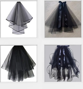 Detail view of four black multi-layered tulle veils featuring delicate ribbon bow accents