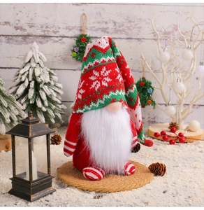 Close-up of a festive Christmas gnome with a long knitted hat and white plush beard