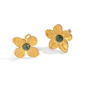 Vintage gold flower stud earrings featuring inlaid green turquoise stones on white background