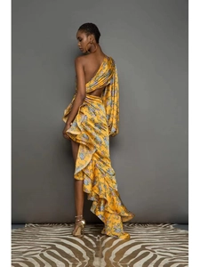 Detail showing the one-shoulder design and open-back floral dress with ruffled hem