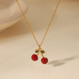 Dettaglio della collana placcata in oro 18 carati con ciondolo a ciliegia rossa e foglia