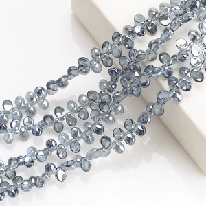 Macro shot of blue-gray crescent moon crystal pendants with high clarity and glass luster