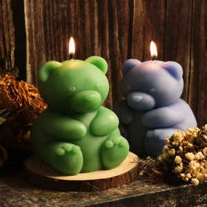 Detail view of sitting bear silicone candle mold crafts in green and purple colors