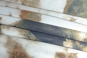 Macro shot of abstract tie-dye fabric texture in earth tones with soft pleated details