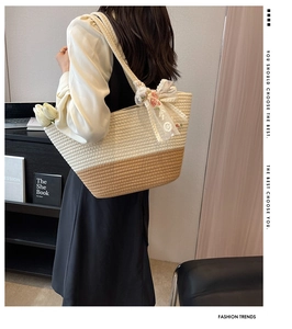 Detail of two-tone woven tote bag with delicate floral embroidery lace bow accessory