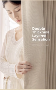 Close-up of beige linen curtains showing thick texture and heavy elegant draping