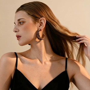 Retro C-shaped leopard print flocking earrings on a model showing classic vintage style