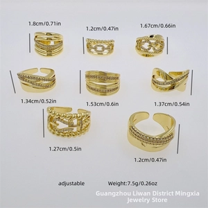 Detailed view of 8 different 18K gold plated zircon rings with adjustable band designs