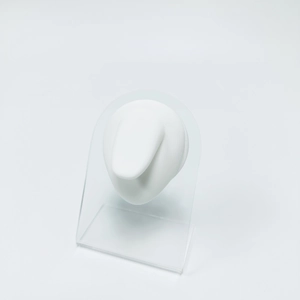 Clear acrylic U-shaped stand holding a white silicone ear model for piercing practice