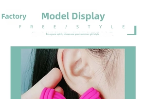 Close-up of pink textured acrylic triangle stud earrings worn by a model