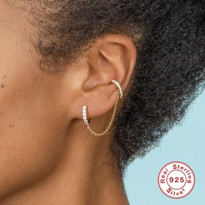 Golden S925 sterling silver chain earrings with pavé crystals shown on a model