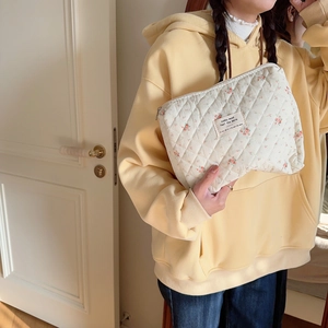 Quilted floral makeup bag with soft fabric texture and vintage zipper detail