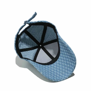 Interior detail of washed denim baseball cap showing sweatband and adjustable metal buckle