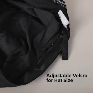 Detail view of the adjustable velcro strap and wash care label inside the plaid hat