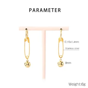 Detail of gold safety pin earrings with 8mm beads, stainless steel material specifications
