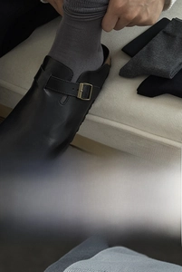 Detail of grey crew socks featuring textured ribbed cuffs and premium elastic fiber