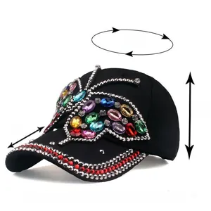 Detailed view of black baseball cap with rhinestone butterfly and size specifications