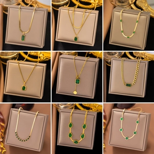Detailed grid showing nine styles of gold necklaces with emerald green gems on display