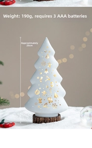White ceramic Christmas tree light with 25cm height and festive golden cutout patterns