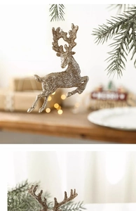 Detail of jumping reindeer Christmas ornament with champagne gold glitter and bow