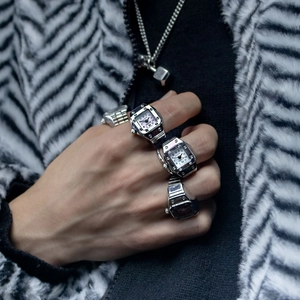 Stylish silver alloy finger ring watch with quartz movement worn on hand with fur texture