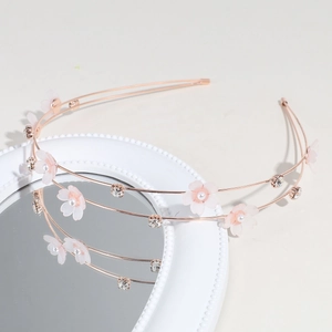 Detail of double-layered rose gold headband with pink gauze flowers and pearls