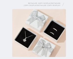 Elegant white jewelry gift box with silver ribbon for necklaces and couple rings