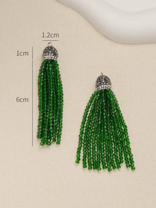Detail view of green beaded tassel earrings with silver caps and 6cm size dimensions