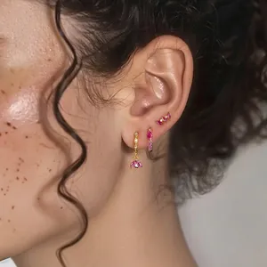 Elegant S925 silver gold-plated earrings with marquise pink zircons on female model