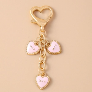 Chic gold heart keychain with three pink enamel Love pendants and large clasp
