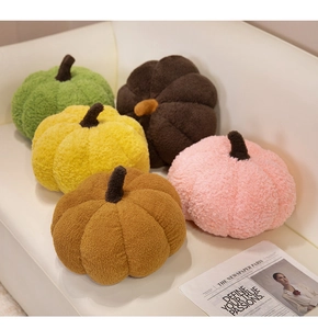 Detailed texture of colorful Nordic pumpkin plush pillows on a cozy leather sofa