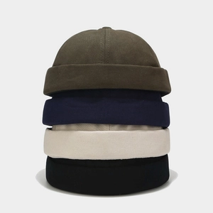 Close-up of four cotton docker hats in green, navy, beige and black colors