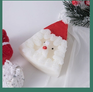 Top view of Santa Claus scented candle with pine branches and red berries in festive setting