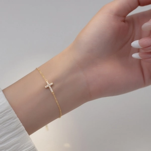 Minimalist gold sterling silver bracelet featuring a dainty cross pendant with pavé diamonds