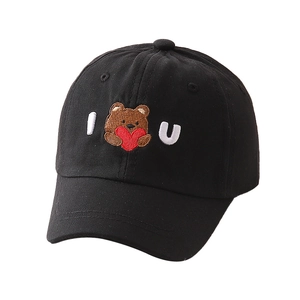 Dettaglio del ricamo orsetto con cuore su cappellino da baseball in cotone nero per bimbi