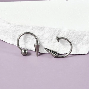 Titanium cone horseshoe ring on a stone, punk style body jewelry for lip and ear