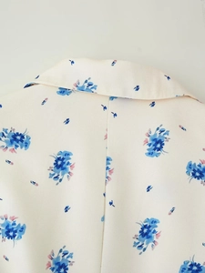 Detailed view of floral blazer lapel featuring precise stitching and textured fabric