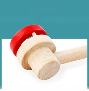 Close-up of the premium natural wood handle and red disk of the breath trainer toy