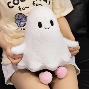 Close-up of soft white plush ghost toy with pink feet and cute embroidered face details