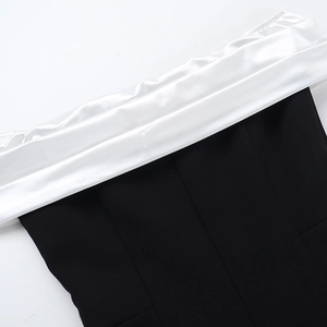 Detail of black and white contrast neckline with satin fabric and premium stitching