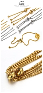 Detailed macro view of adjustable 18k gold and silver plated slider chains with charms