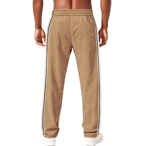 Detail view of khaki corduroy pants with side stripes and elastic waist design
