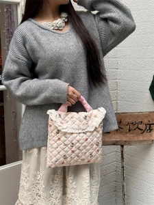 Pink quilted 11-inch laptop bag with bear print and white lace trim detail