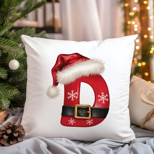 Christmas pillow cover with festive red letter D and Santa hat on white background