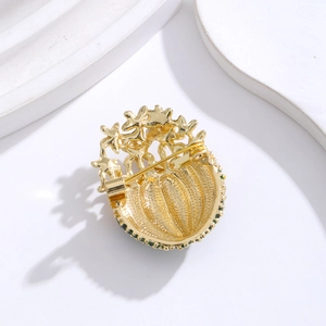 Elegant gold cactus brooch with green crystals and fine textured finish on back